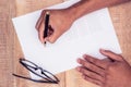 Cropped hand of businessman writing on paper Royalty Free Stock Photo