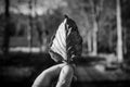 Cropped hand holding a dry leaf in black and white Royalty Free Stock Photo