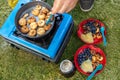 Man making pancakes at campsite