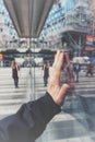 cropped hand of person against glass window