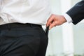 Hand Pickpocketing Wallet Of Businessman Royalty Free Stock Photo