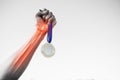 Cropped hand of sportsperson holding gold medal