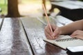 Cropped hand of woman writing book on the desk, education outdoor concept, copy space use for presentation Royalty Free Stock Photo