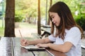 Cropped hand of woman writing book on the desk, education outdoor concept Royalty Free Stock Photo