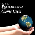 Cropped hands of caucasian woman holding earth with day for preservation of the ozone layer text Royalty Free Stock Photo