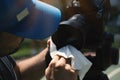 Cropped Hands of Man Cleaning Camera Lens