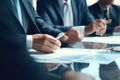 cropped hands three business people talking at a conference table