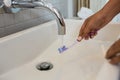 Cropped hands of woman cleaning brush in sink Royalty Free Stock Photo