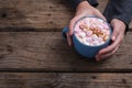 Cropped hands of woman holding mug of hot chocolate drink with copy space at table in coffee shop Royalty Free Stock Photo