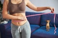 Woman checking waist size after workout at home Royalty Free Stock Photo