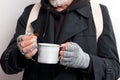 Cropped homeless beggar with cup for money