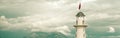 Cropped horizontal image lighthouse on cloudy sky Royalty Free Stock Photo