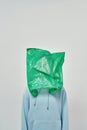 Cropped human with plastic bag on head on white