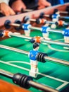 Cropped image of active people playing foosball. table soccer plaers. Friends play together table football Royalty Free Stock Photo