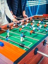 Cropped image of active people playing foosball. table soccer plaers. Friends play together table football Royalty Free Stock Photo