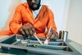 cropped image of african american prisoner eating Royalty Free Stock Photo