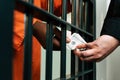 cropped image of african american prisoner giving money to prison guard Royalty Free Stock Photo