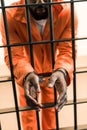 cropped image of african american prisoner in handcuffs behind prison Royalty Free Stock Photo