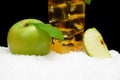 Cropped image of apple juice on black on snow Royalty Free Stock Photo