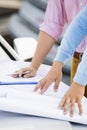 Cropped image of architects with blueprints on car at site Royalty Free Stock Photo