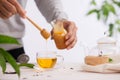 Cropped image of arista pouring honey into cup of tea Royalty Free Stock Photo