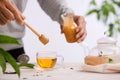 Cropped image of arista pouring honey into cup of tea Royalty Free Stock Photo