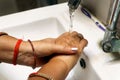 Cropped Image Of an asian Woman Washing Hands In Sink At Home. Selective focus Royalty Free Stock Photo