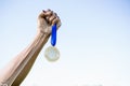 Cropped image of athlete holding gold medal