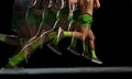 Cropped image of athletic, muscular male legs in motion, running against black background with stroboscope effect.