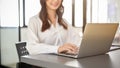 Cropped image, Attractive Asian businesswoman typing on notebook keyboard, using laptop