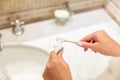 Cropped image of attractive woman hand applying toothpaste on toothbrush in bathroom. Beauty healty wellness morning concept Royalty Free Stock Photo