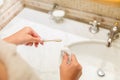 Cropped image of attractive woman hand applying toothpaste on toothbrush in bathroom. Beauty healty wellness morning concept Royalty Free Stock Photo