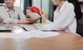 Cropped image of attractive young Asian woman accepting a bouquet of red roses from boyfriend in office on valentine`s day. Love Royalty Free Stock Photo