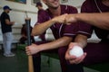 Cropped image of baseball players sitting on bench Royalty Free Stock Photo