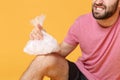 Cropped image of bearded fitness sporty guy sportsman in headband t-shirt in home gym isolated on yellow background