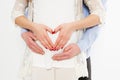 Cropped image of beautiful pregnant woman and her handsome husband hugging the tummy.Sign of Love.Happy event,birth of a child Royalty Free Stock Photo