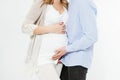 Cropped image beautiful young couple expecting baby standing together and touching belly isolated on white background Royalty Free Stock Photo