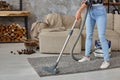 Cropped image of beautiful young woman using a vacuum cleaner while cleaning carpet in the house Royalty Free Stock Photo