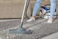 Cropped image of beautiful young woman using a vacuum cleaner while cleaning carpet in the house Royalty Free Stock Photo