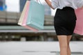 Cropped image of beauty Asian woman holding colorful shopping bags on city street. Royalty Free Stock Photo