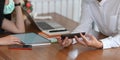 Cropped image of business people working with white blank screen computer laptop, tablet and smartphone. Royalty Free Stock Photo