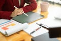 Cropped image of business woman working on digital tablet computer in her workplace