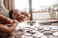 Cropped Image Of Businessman counting coins Using Calculator at Desk In Office. Businessperson Hand Counting Coins. Business Royalty Free Stock Photo