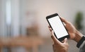 Cropped image businessman hands are using a white blank screen smartphone over blurred background