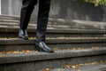 Cropped image of a businessman walking down the stairs in front of the building Royalty Free Stock Photo