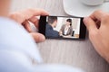 Cropped image of businessman watching movie