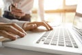 Cropped image of businessmen using laptop for sales performance at a office