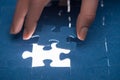 cropped image of businesswoman inserting last missing puzzle,