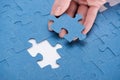 cropped image of businesswoman inserting last missing puzzle,