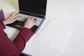 Cropped image of businesswoman's hands using laptop at desk Royalty Free Stock Photo